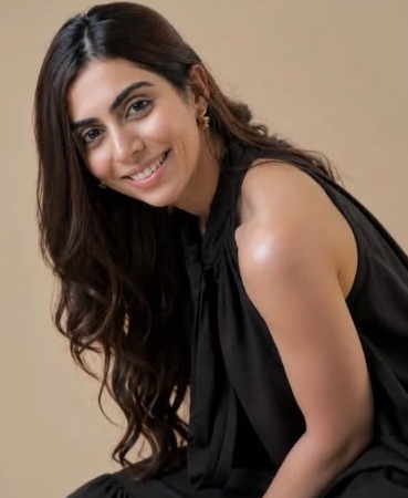 Portrait of Simran Patil smiling, in a black halter top